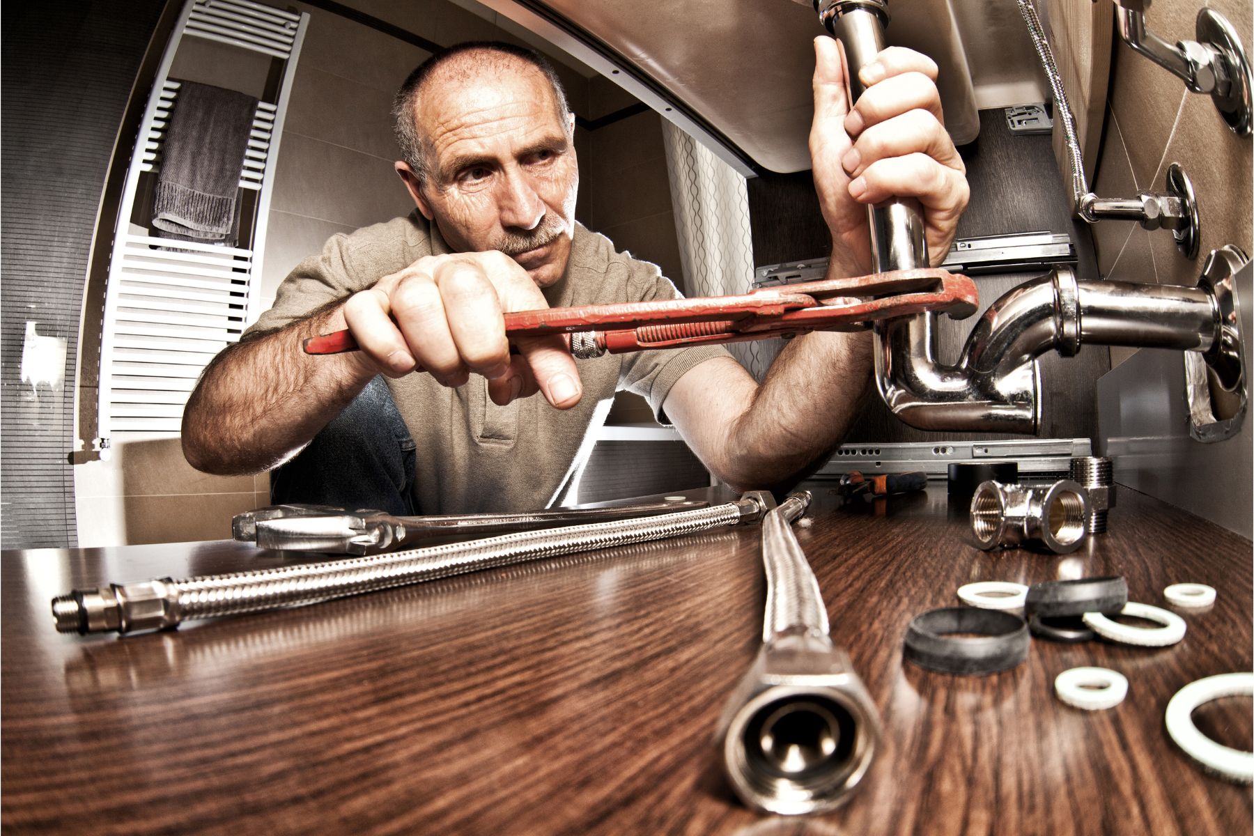plumber fixing under sink